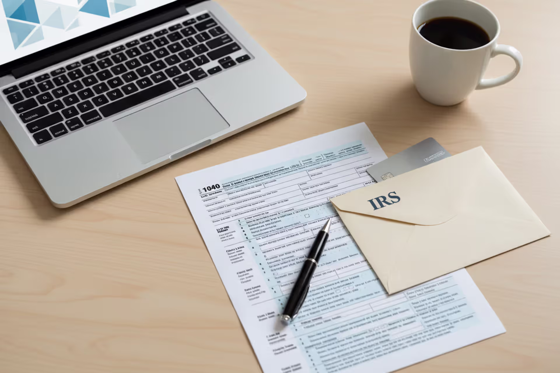 Tax filing documents, laptop, and office desk setup